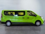 the small green van is parked in a large room