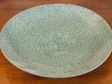 a cracky plate sitting on a wooden table