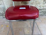 a red chair that has a tag on it