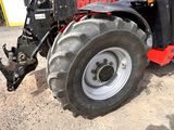a tractor that is parked on the side of the road