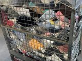 a metal cart with many items in it in a warehouse