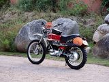 a motorcycle parked on the side of the road next to some rocks
