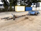 a trailer with a trailer attached to it in a parking lot
