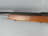 a close up of a rifle on a white surface