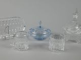 four pieces of glass sitting on top of a table next to each other