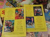 a lot of comic books on the table together