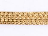 a close up of a gold bracelet on a white surface