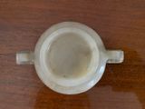 a white cup sitting on a wooden table