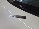 a remote control on the hood of a white car
