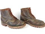 pair of brown leather boots with laces on them on a white surface