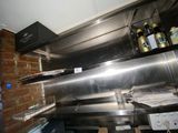 stainless steel counter top in a commercial kitchen with a brick wall