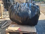 a large black bag sitting on top of a pallet