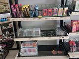 a lot of makeup products on the shelves in the store