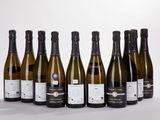 six bottles of wine are lined up in a row on a white surface