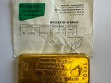 a close up of a piece of gold on a piece of paper