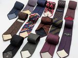 a lot of ties that are laying on the table