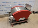 a red and silver machine sitting on top of a wooden pallet