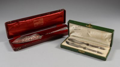 two silverware items in a red box on a table