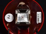 a watch that is sitting on top of a red stand