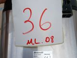 a person holding a piece of paper with the number 36 on it