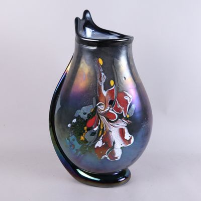 a black vase with a colorful design on it