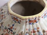 a close up of a vase with a flower design on it