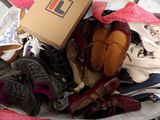a basket full of shoes and a box on a table