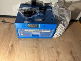 a blue machine that is sitting on the floor