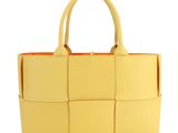 a yellow handbag on a white background with a white background