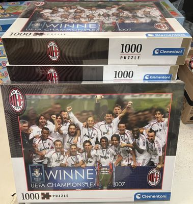two puzzle boxes with a picture of a soccer team on them