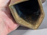 a hand that is holding a piece of pottery