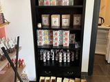a black bookcase filled with lots of different types of goods