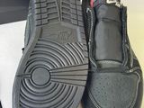 a pair of black shoes that are on a table