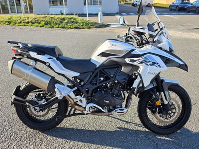 a white and black motorcycle parked in a parking lot