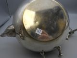 a silver tea pot with a sticker on it