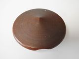 a close up of a brown object on a white surface