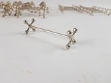 a lot of silver objects on a white surface