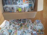 une boîte remplie de timbres posée par terre dans une pièce