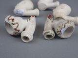 three small white porcelain figurines of different shapes and sizes