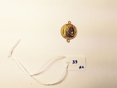 a gold medal with a picture of a woman on it