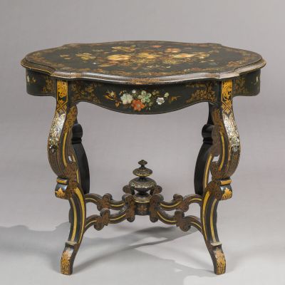 a small table with a bird motif on the top