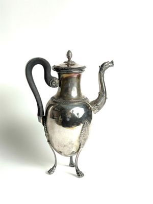 a silver tea pot with a black handle on a white background