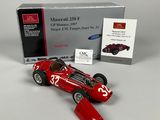 a red model of a racing car in front of a box
