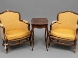 two chairs and a table with a small table on top of it