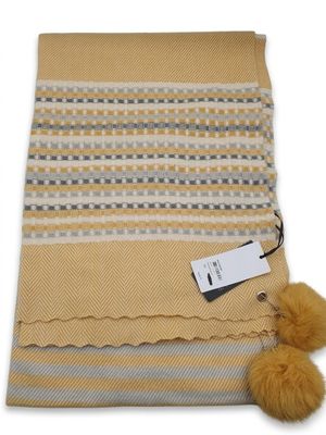 a blanket with a pom pom on top of it