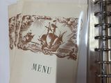 a picture of a menu in a binder on a table