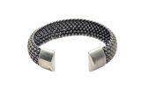 a close up of a bracelet with a metal clasp on a white background