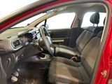 the interior of a red car with the door open and the driver ' s seat down