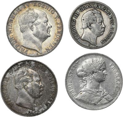 four different types of silver coins on a white background