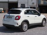 a small white car parked in front of a building